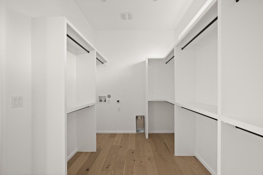 Laundry area featuring light wood-style floors, washer hookup, and hookup for an electric dryer