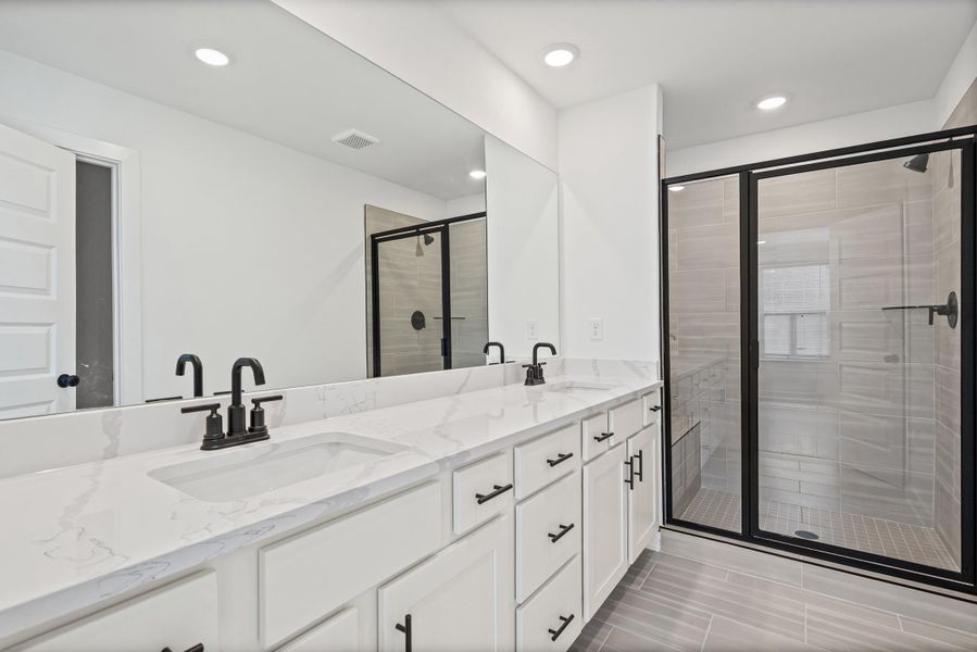 Double vanity with rectangular undermount sinks, quartz countertops, and matte black fixtures
