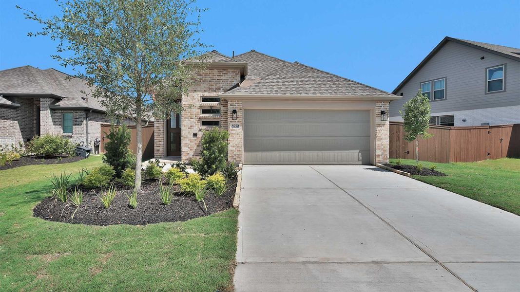 Front exterior of a new home in Meridiana, Manvel, TX, highlighting curb appeal (Image 1). Front exterior of a new home in Meridiana, Manvel, TX, highlighting curb appeal (Image 1).