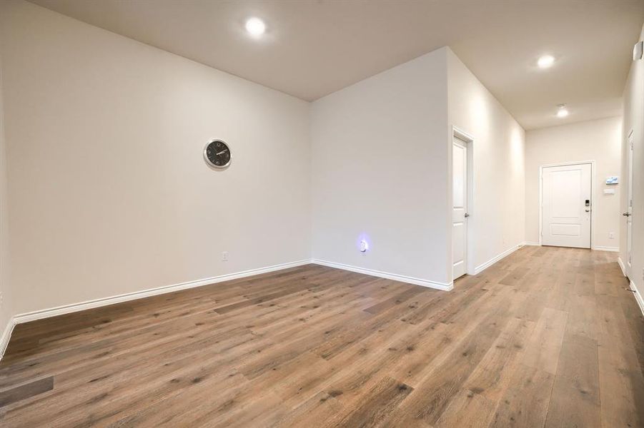 Unfurnished room featuring wood finished floors and recessed lighting Unfurnished room featuring wood finished floors and recessed lighting