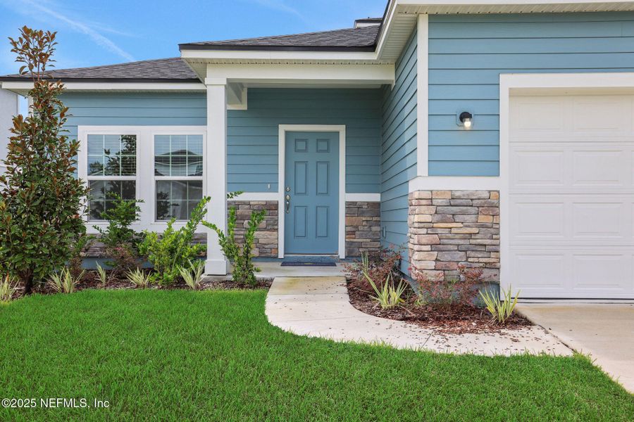 Front exterior of a new home in Cordova Palms, St. Augustine, FL, highlighting curb appeal (Image 22).