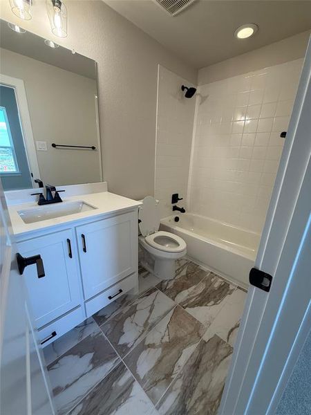 Full bath with vanity, shower / bathtub combination, light marble finish flooring, and recessed lighting Full bath with vanity, shower / bathtub combination, light marble finish flooring, and recessed lighting