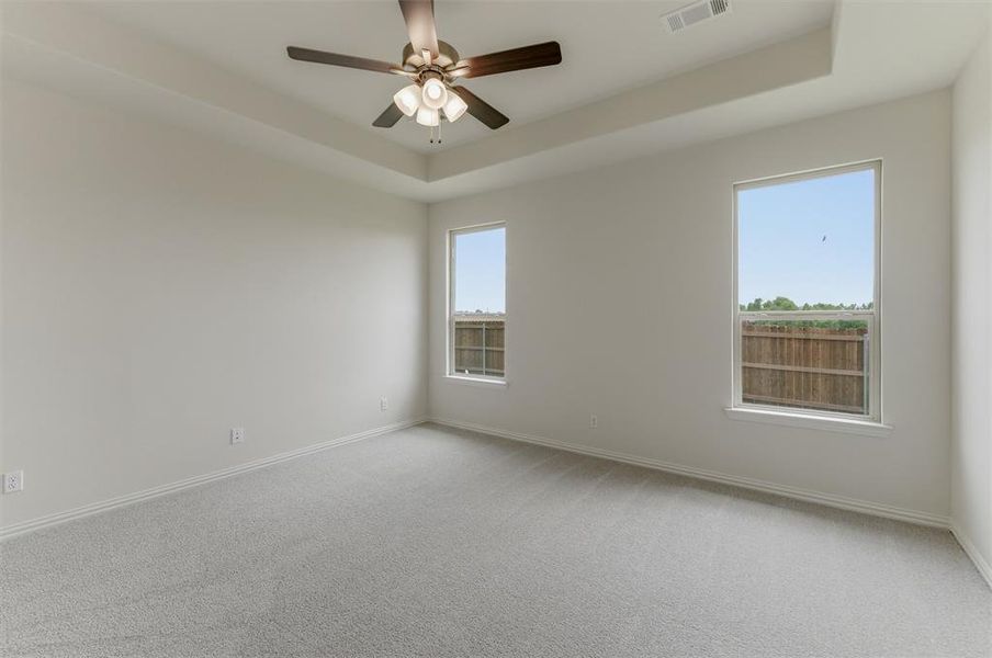 Spacious room featuring light gray carpeting and white walls