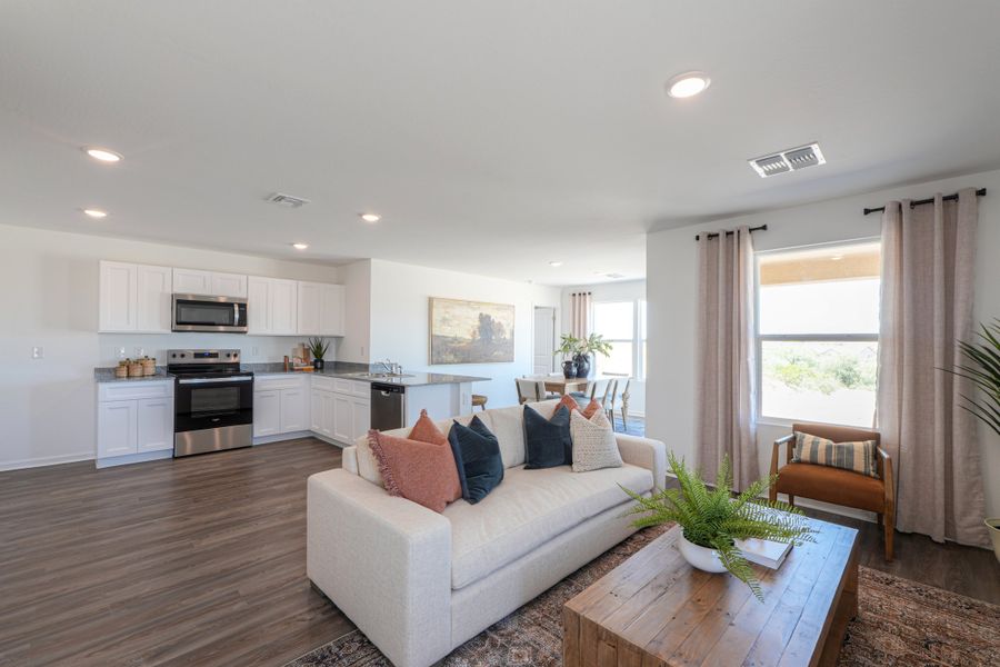A living room with a couch and a table. A living room with a couch and a table.