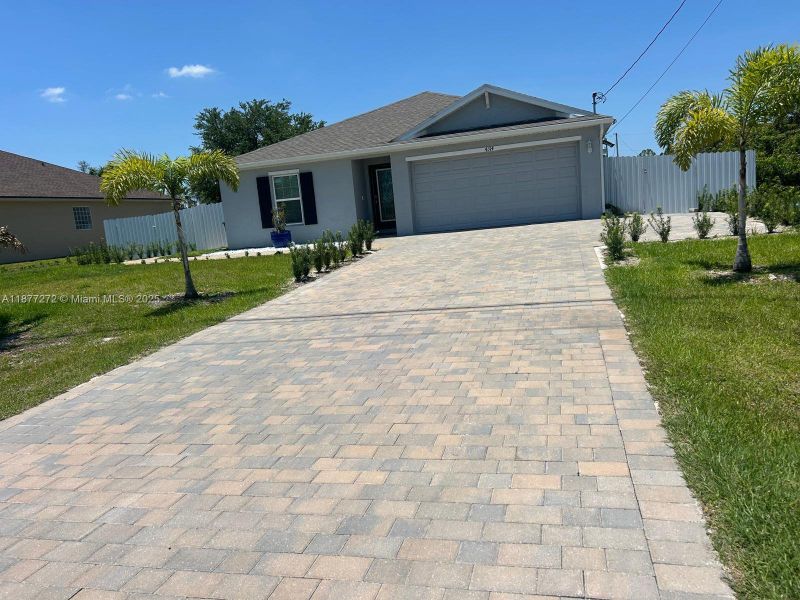 Front exterior of a new home in , Cape Coral, FL, highlighting curb appeal (Image 14). Front exterior of a new home in , Cape Coral, FL, highlighting curb appeal (Image 14).