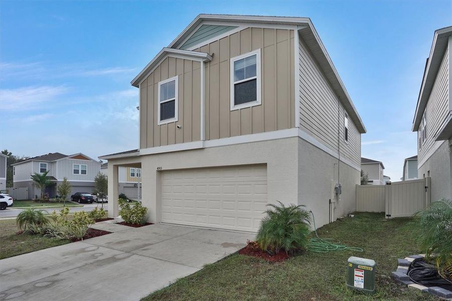 Front exterior of a new home in Hammock Reserve, Haines City, FL, highlighting curb appeal (Image 21).