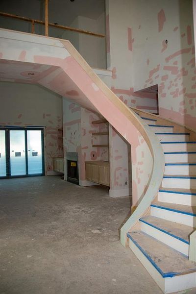 Show stopping spiral staircase with white oak steps, adding timeless beauty