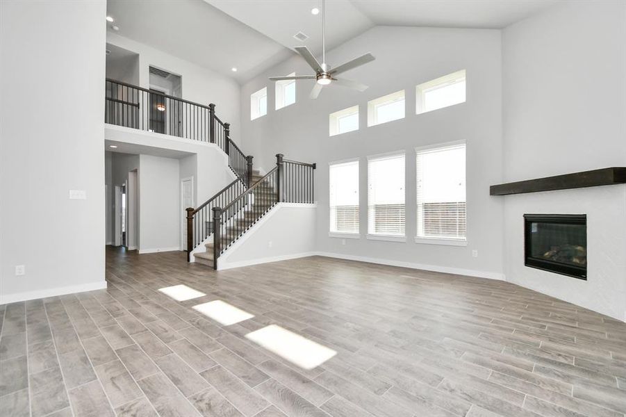 Bring the family and guests together in the welcoming family room! Enjoy the expansive space adorned with high ceilings, recessed lighting, a stylish ceiling fan, custom paint, exquisite flooring, and generously sized windows that fill the room with an abundance of natural light, creating a warm and inviting atmosphere for everyone to enjoy. The open stair case adds the final touch to this impressive space. As-built interior colors and selections may vary.