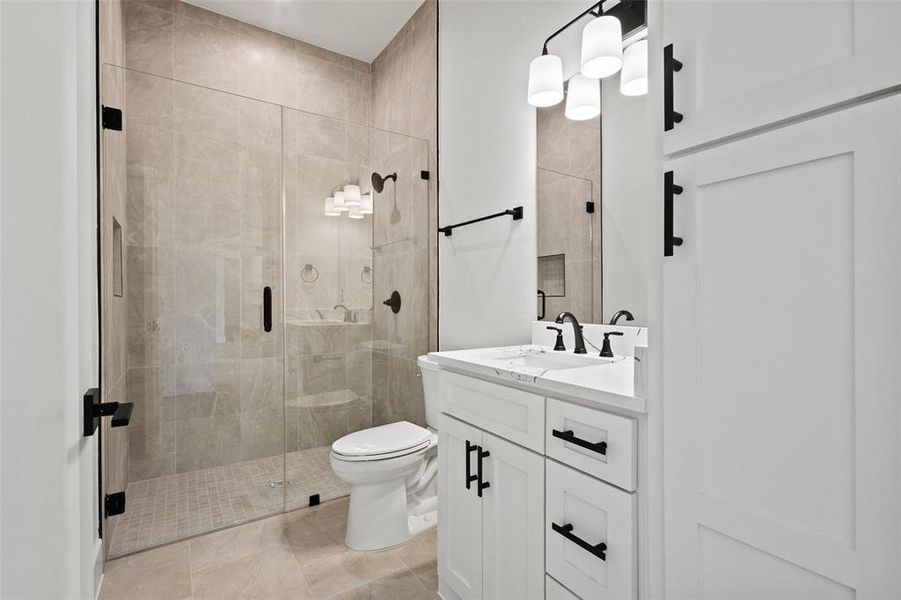 Full bathroom with vanity, a shower stall, and light tile patterned floors Full bathroom with vanity, a shower stall, and light tile patterned floors