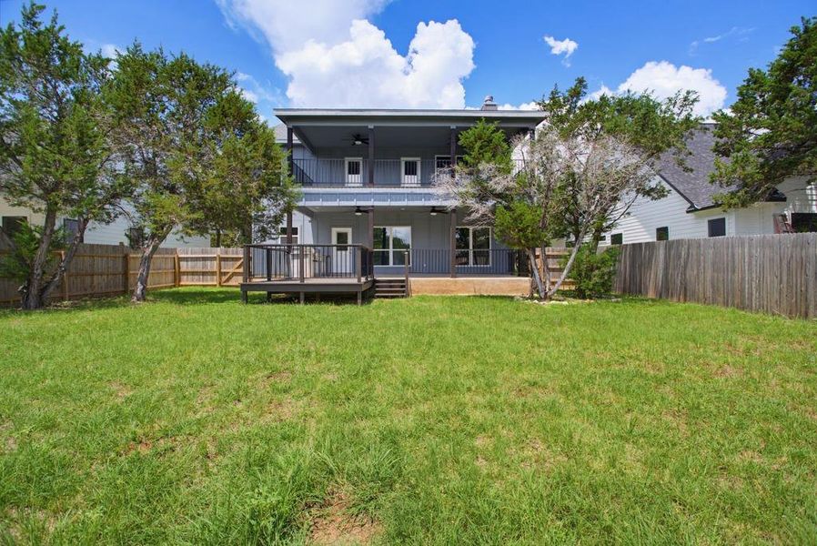 A spacious backyard with mature trees and a multi-level deck offers generous outdoor living. A spacious backyard with mature trees and a multi-level deck offers generous outdoor living.