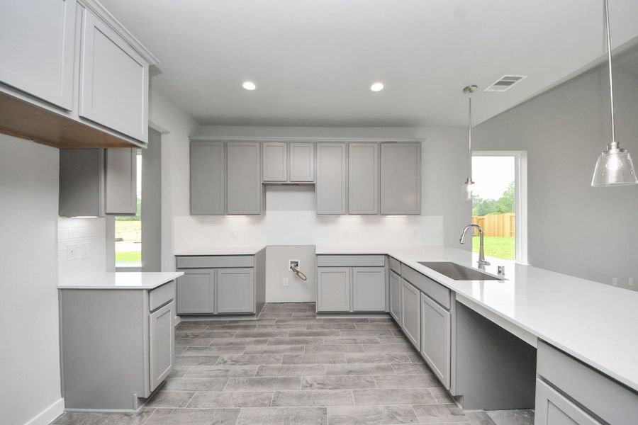 This kitchen is by far any chef’s dream! This spacious kitchen features high ceilings, light stained wood cabinets, granite countertop, SS appliances, modern tile backsplash, recessed lighting, extended counter space, and space for breakfast bar, and a walk-in pantry all overlooking your huge family room. Sample photo of completed home with similar floor plan. Actual colors and selections may vary.