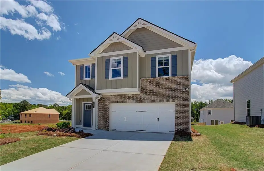 Front exterior of a new home in Enclave at Evergreen, Fairburn, GA, highlighting curb appeal (Image 1). Front exterior of a new home in Enclave at Evergreen, Fairburn, GA, highlighting curb appeal (Image 1).