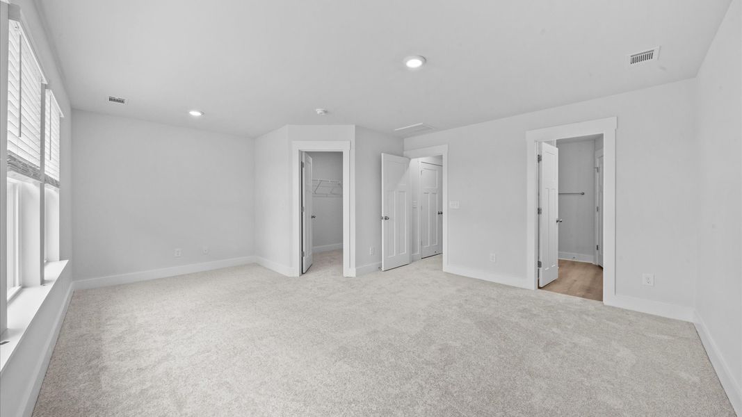 Plush carpeted primary suite in two story townhome at Ransdell Pointe by DRB Homes in Spartanburg, SC