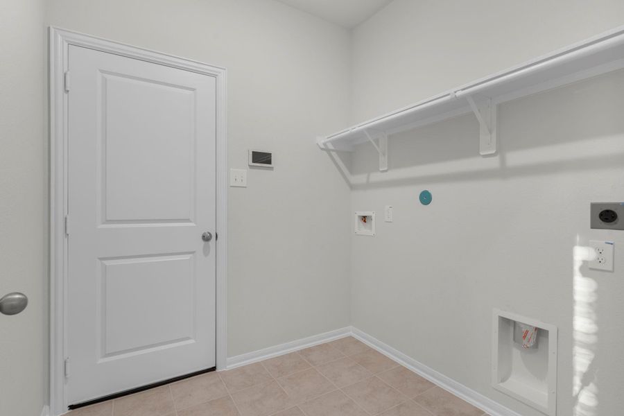The utility room is conveniently located on the first floor and offers space for a full-size washer and dryer along with built-in shelving for added storage. Its practical design keeps laundry day simple and organized while maintaining a clean, modern look. The utility room is conveniently located on the first floor and offers space for a full-size washer and dryer along with built-in shelving for added storage. Its practical design keeps laundry day simple and organized while maintaining a clean, modern look.