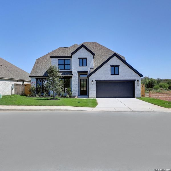 Front exterior of a new home in Alsatian Oaks, Castroville, TX, highlighting curb appeal (Image 2). Front exterior of a new home in Alsatian Oaks, Castroville, TX, highlighting curb appeal (Image 2).