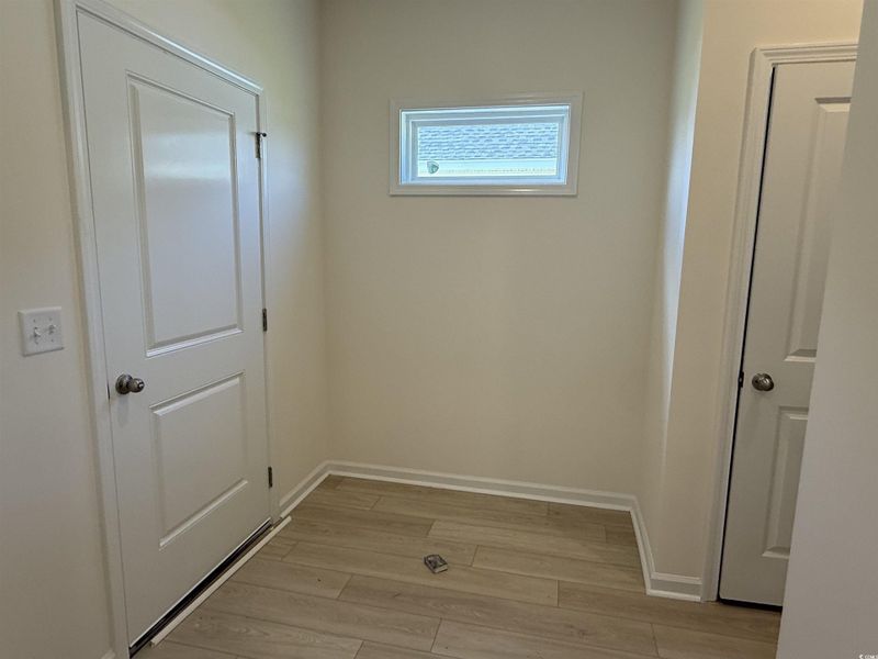 Kitchen featuring gas stove, light wood-style flooring, an island with sink, tasteful backsplash, and white cabinets Kitchen featuring gas stove, light wood-style flooring, an island with sink, tasteful backsplash, and white cabinets