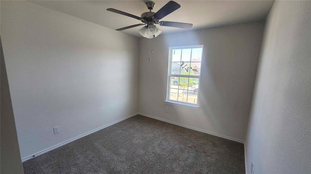 Neutral painted walls with white trim and a single window