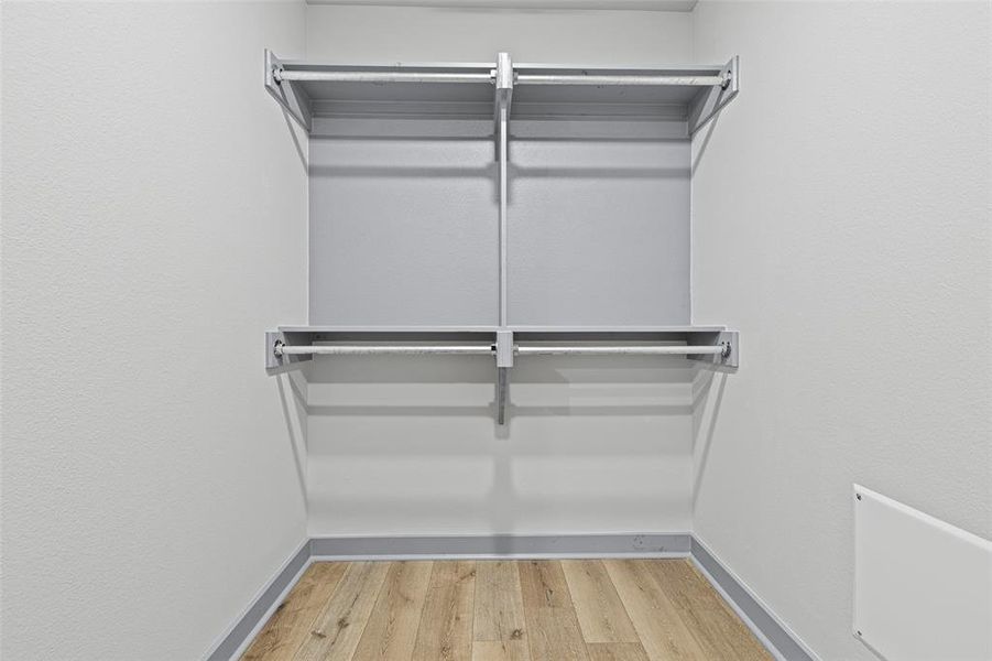 Spacious closet featuring light wood finished floors Spacious closet featuring light wood finished floors