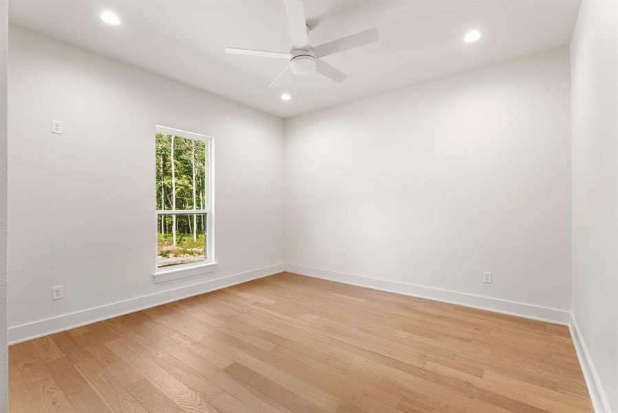 Spare room featuring light wood-style floors, recessed lighting, and a ceiling fan