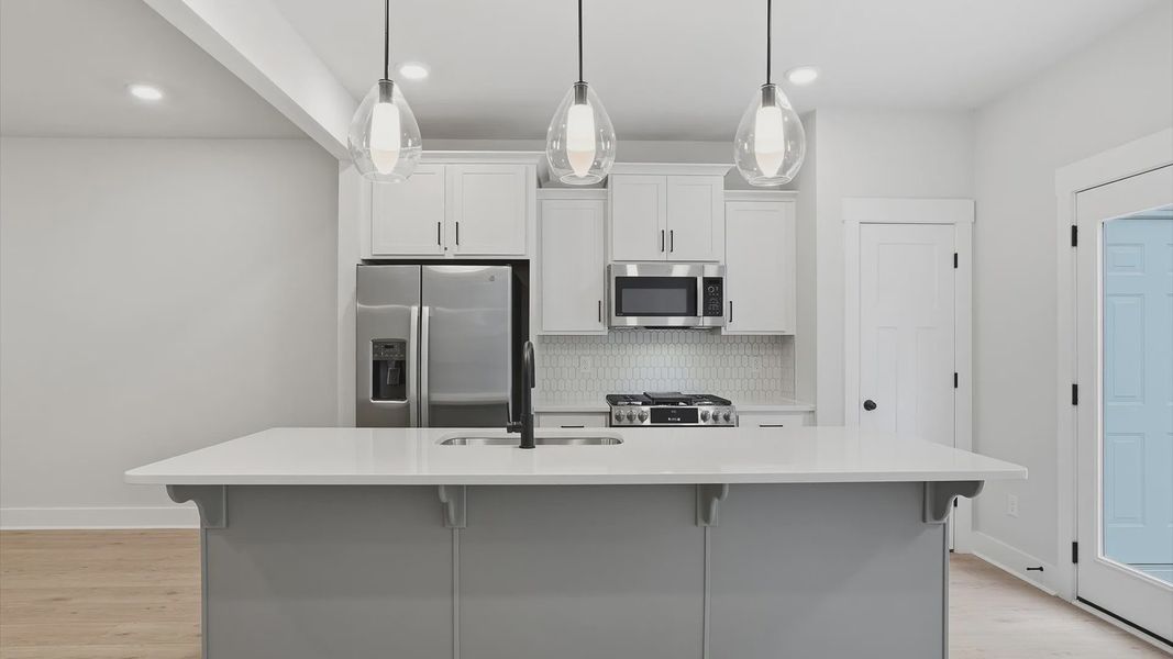 Accomplished design in a kitchen that blends function and form with a right-sized island located at Anna's Pointe