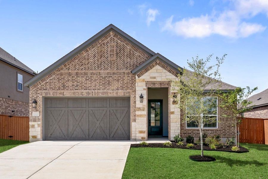 Our beautiful Kendall floor plan comes with a long driveway, a cedar garage door, and lush front yard landscaping.