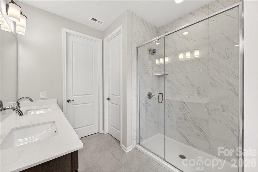 Dual vanity primary bathroom with walk-in shower Dual vanity primary bathroom with walk-in shower