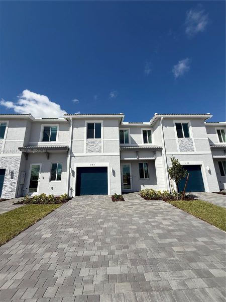 Front exterior of a new home in , Homestead, FL, highlighting curb appeal (Image 1). Front exterior of a new home in , Homestead, FL, highlighting curb appeal (Image 1).