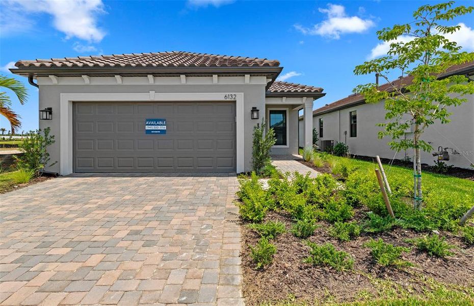 Front exterior of a new home in Talon Preserve on Palmer Ranch, Nokomis, FL, highlighting curb appeal (Image 1). Front exterior of a new home in Talon Preserve on Palmer Ranch, Nokomis, FL, highlighting curb appeal (Image 1).