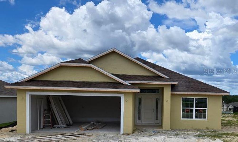 Front exterior of a new home in Twisted Oaks, Beverly Hills, FL, highlighting curb appeal (Image 15).
