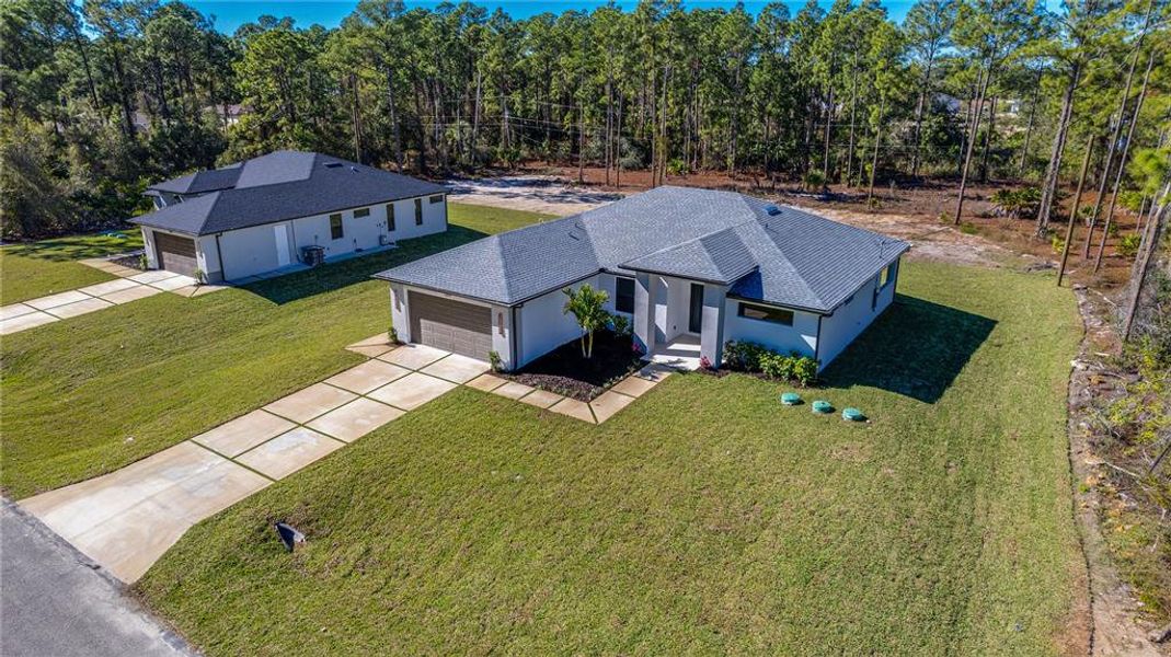 Front exterior of a new home in , Lehigh Acres, FL, highlighting curb appeal (Image 19). Front exterior of a new home in , Lehigh Acres, FL, highlighting curb appeal (Image 19).