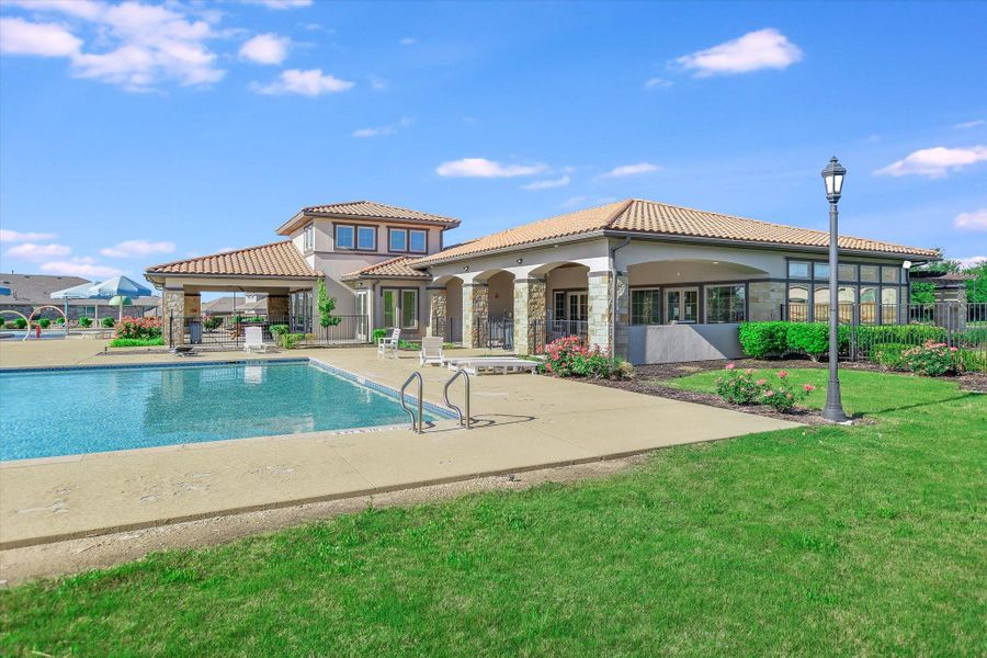 Community pool featuring a patio, a yard, and fence