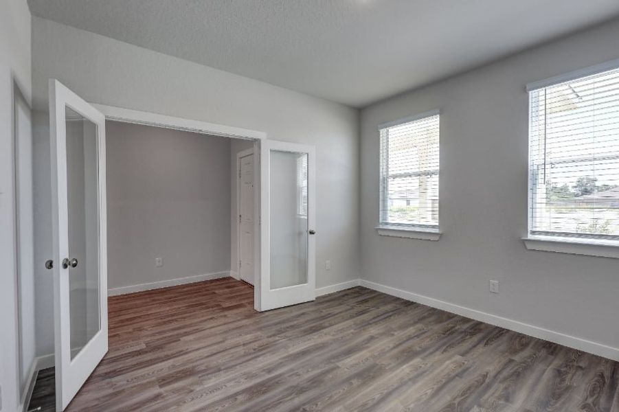 A room with a wood floor and white walls. A room with a wood floor and white walls.