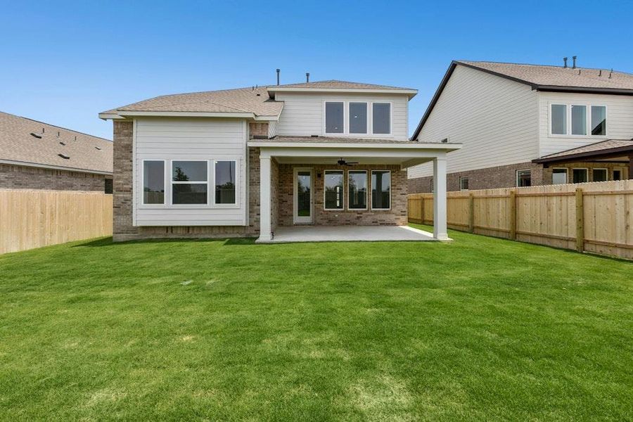 Front exterior of a new home in Santa Rita Ranch, Liberty Hill, TX, highlighting curb appeal (Image 1). Front exterior of a new home in Santa Rita Ranch, Liberty Hill, TX, highlighting curb appeal (Image 1).