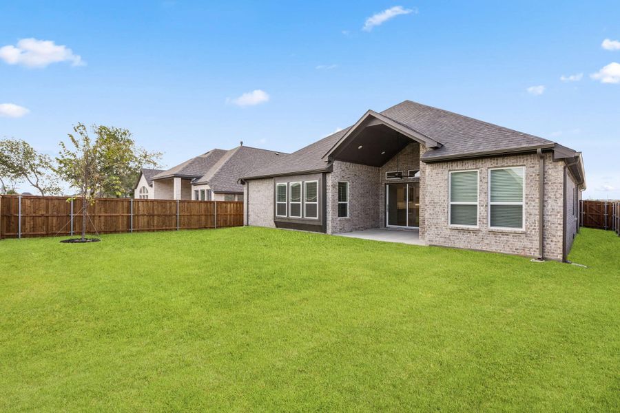 Front exterior of a new home in Trinity Falls, McKinney, TX, highlighting curb appeal (Image 2).