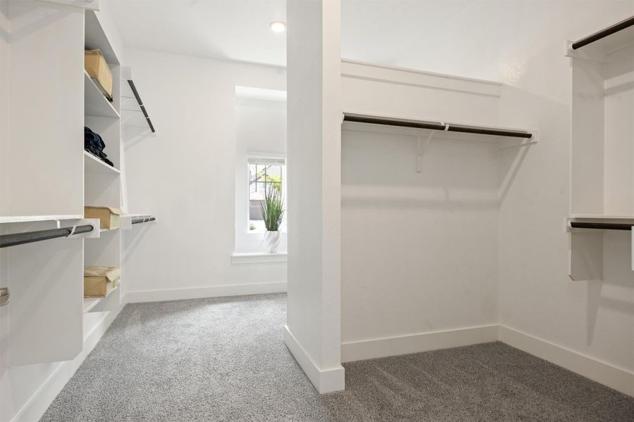 His-and-hers Walk in closet featuring carpet floors His-and-hers Walk in closet featuring carpet floors