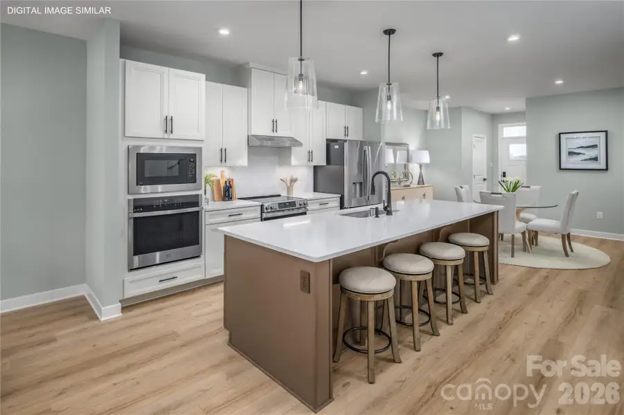 Bright, open kitchen with generous prep space and a large center island. Bright, open kitchen with generous prep space and a large center island.