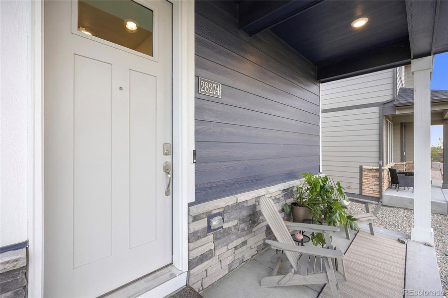 Darling covered front porch to sit out and enjoy a cup of coffee.