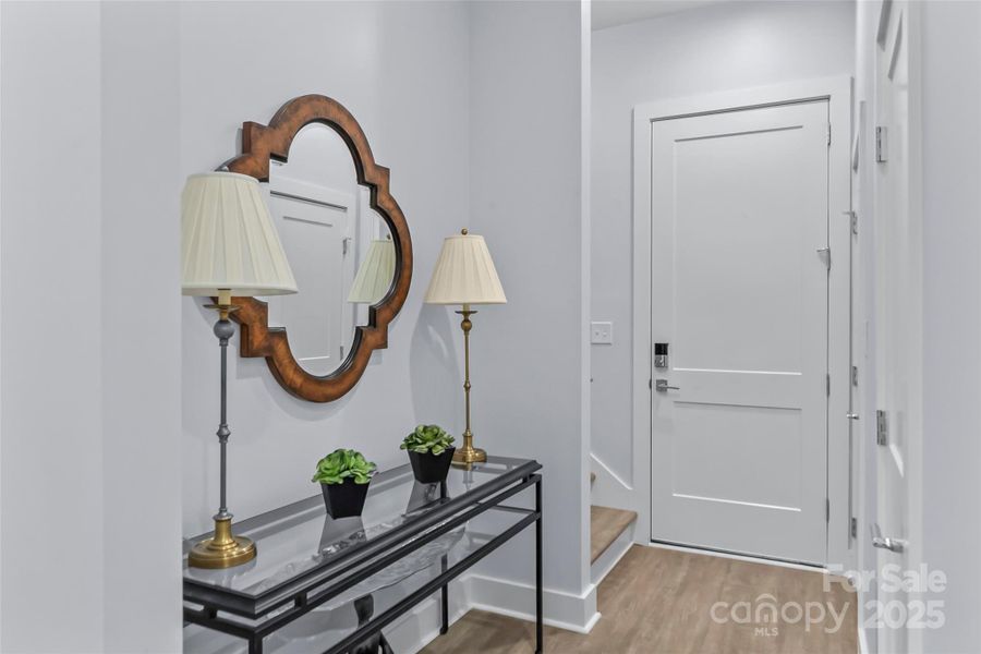Hallway to Stairs and Garage has Closet and Half Bath off of it