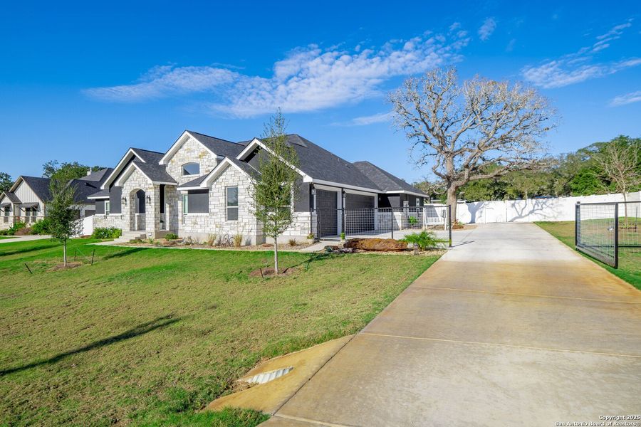 Front exterior of a new home in , La Vernia, TX, highlighting curb appeal (Image 25). Front exterior of a new home in , La Vernia, TX, highlighting curb appeal (Image 25).