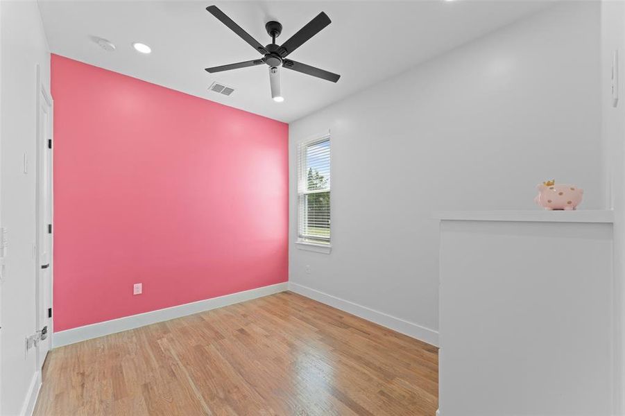 Empty room featuring light wood finished floors, a ceiling fan, and recessed lighting Empty room featuring light wood finished floors, a ceiling fan, and recessed lighting