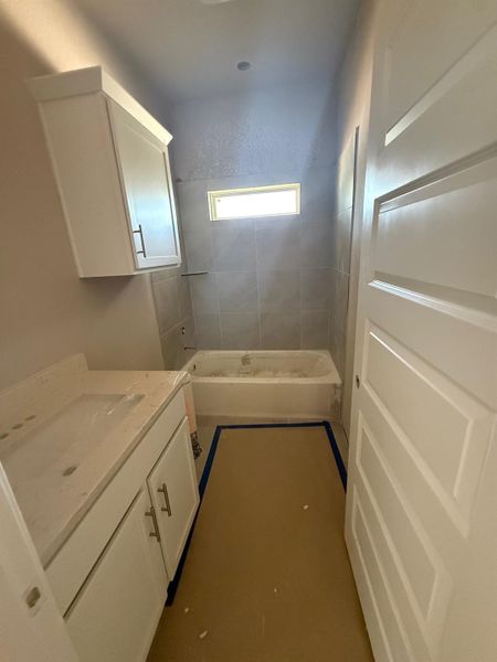 Full bathroom with vanity and washtub / shower combination