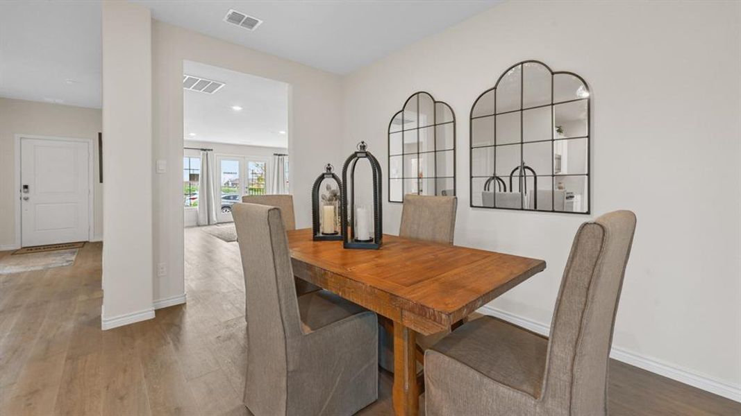 Dining room featuring wood finished floors and recessed lighting Dining room featuring wood finished floors and recessed lighting