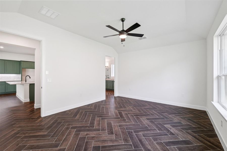 Unfurnished room with a ceiling fan and vaulted ceiling