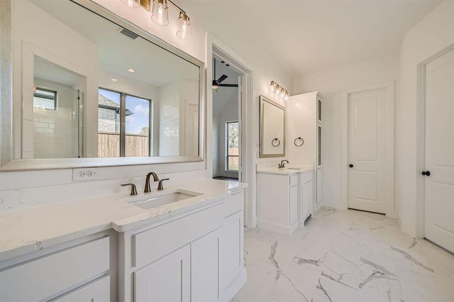 Bathroom featuring vanity and tiled shower