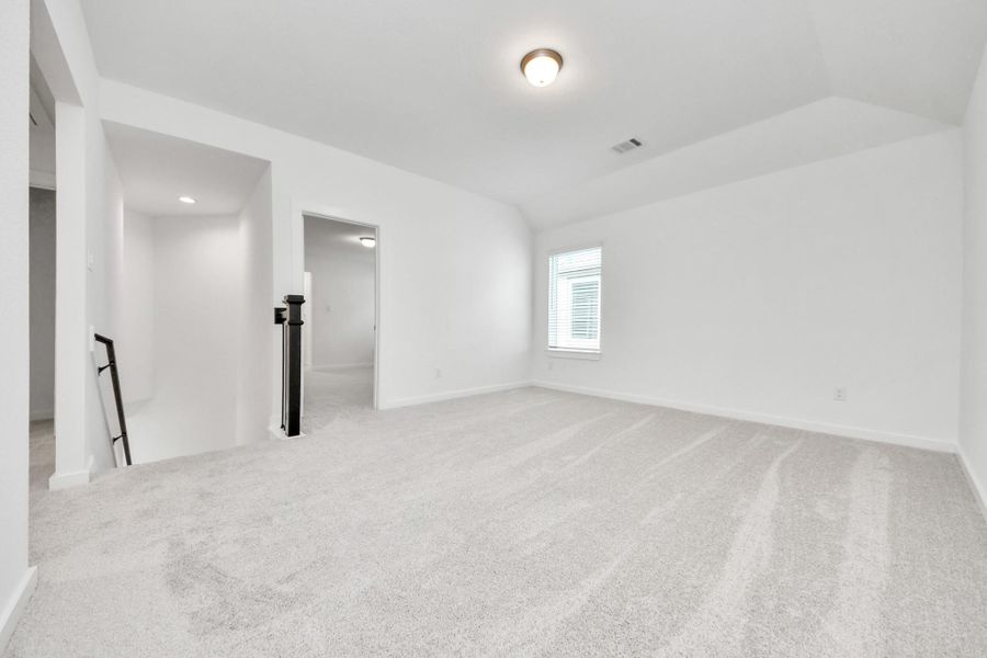 Come upstairs and enjoy a day of leisure in this fabulous game room! This is the perfect hangout spot or adult game room! Features plush carpet, high ceilings, custom paint and windows for plenty of natural light.