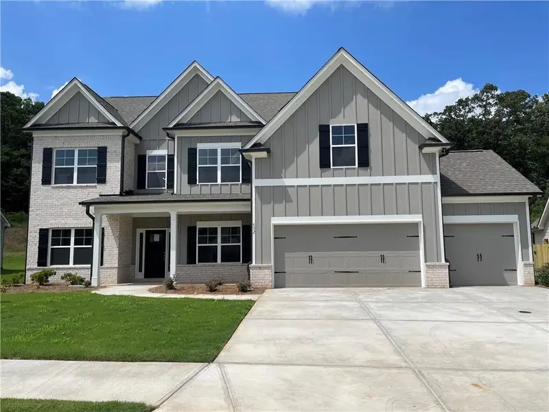 Front exterior of a new home in Hidden Fields, Hoschton, GA, highlighting curb appeal (Image 1).