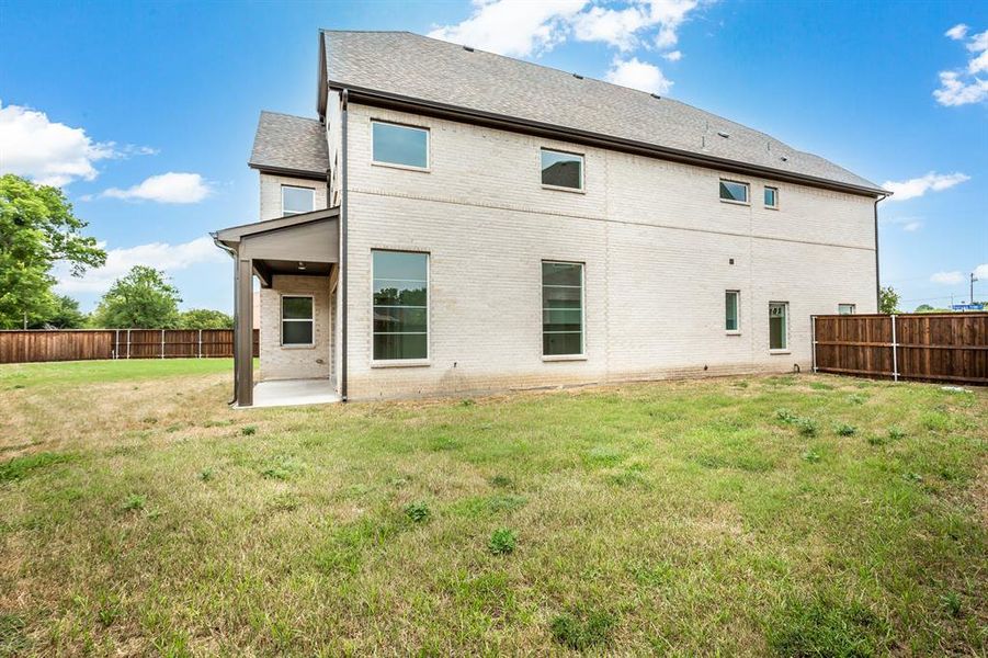 Rear view of property featuring a yard