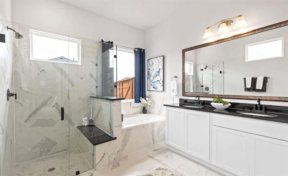 Bathroom featuring tile floors, independent shower and bath, a healthy amount of sunlight, and double sink vanity