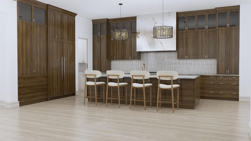 The kitchen features custom cabinets with island storage as well as glass front upper cabinets. The carefully curated tile and quartzite counter tops accent the space. The scullery kitchen and pantry space are located through the pocket door on the left.