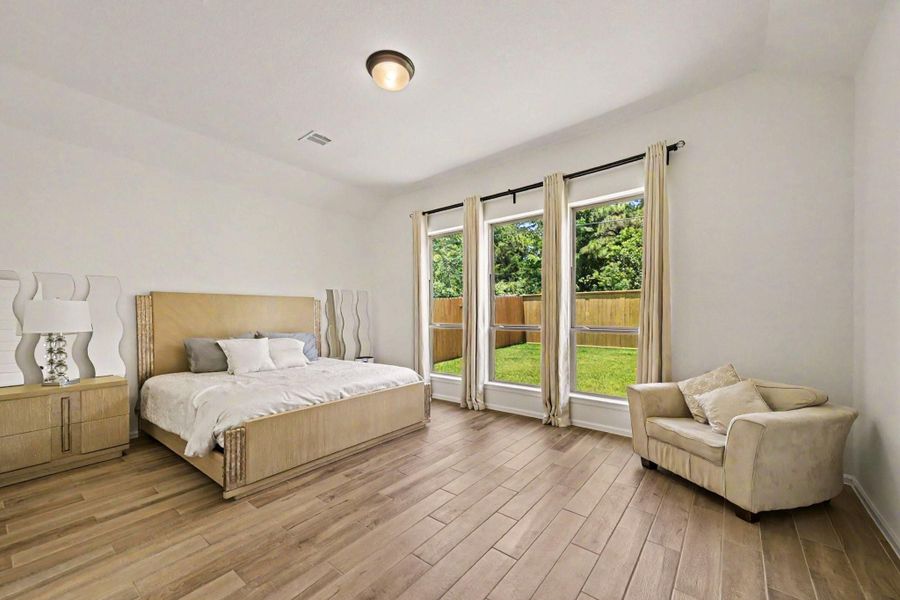 Secluded primary bedroom with backyard views and soaring ceilings. Secluded primary bedroom with backyard views and soaring ceilings.